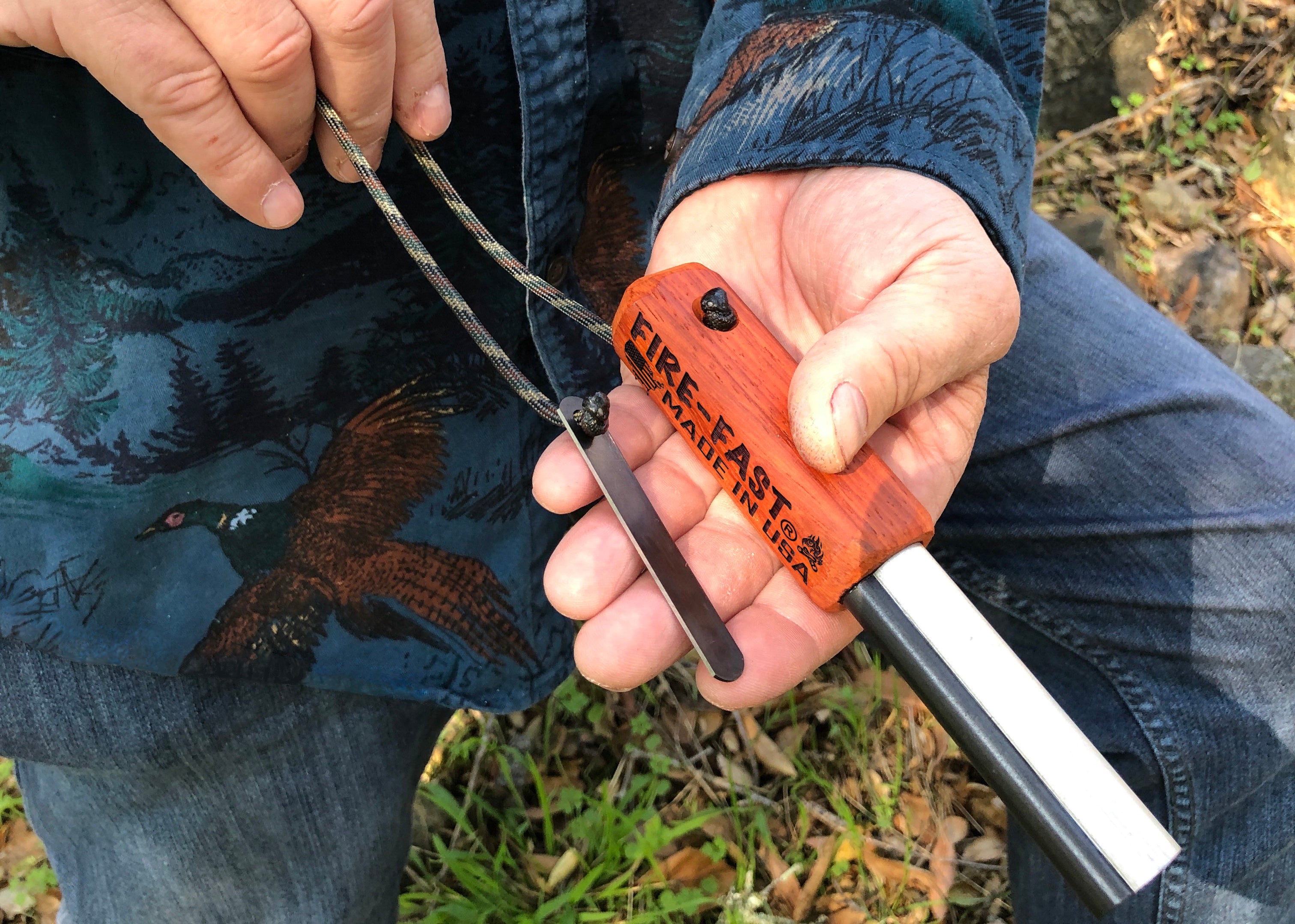 Hand holding Fire-Fast Trekker USA-made waterproof fire starter with ferro rod and striker