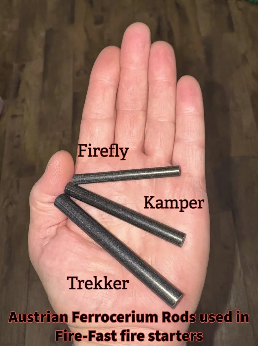 Three Austrian ferrocerium rods labeled Firefly, Kamper, and Trekker held in a hand, used in Fire-Fast fire starters