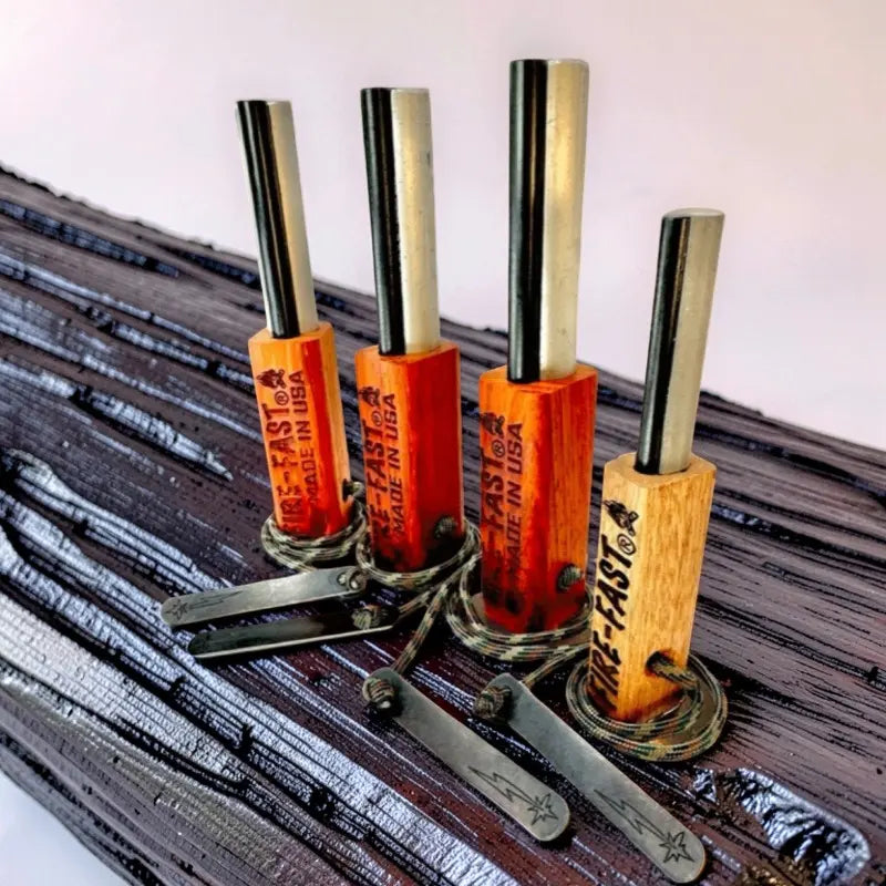 Three Fire-Fast ferro rod Trekker fire starters and one FireFly fire starter, with hardwood handles, strikers, and paracord.