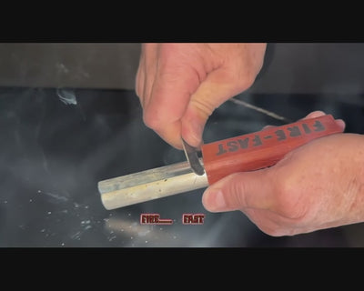 Hands demonstrating USA-made Fire-Fast Trekker waterproof fire starter scraping striker against ferrocerium rod to produce extreme heat and flame-thrower level sparks for reliable ignition in survival scenarios.